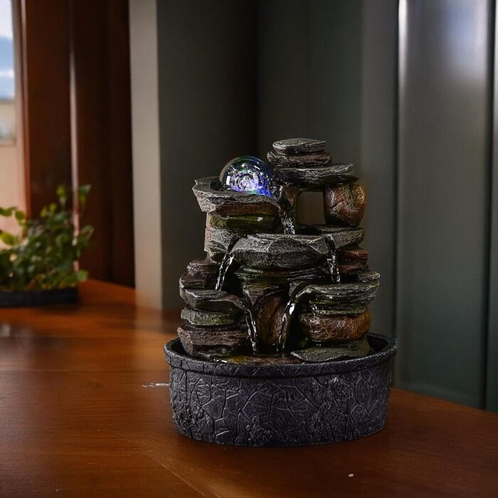 Джерело води Zen'Light від Zimmerbrunnen: природний водоспад з ефектом каменів та кольоровим LED-підсвічуванням. Ідеальна декор для дому, медитації та релаксації. Об'єкт Фен-Шуй для щастя. Висота 23 см (Satya)